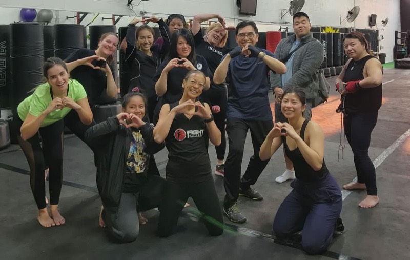 Fight Fitness members making heart hands after workout